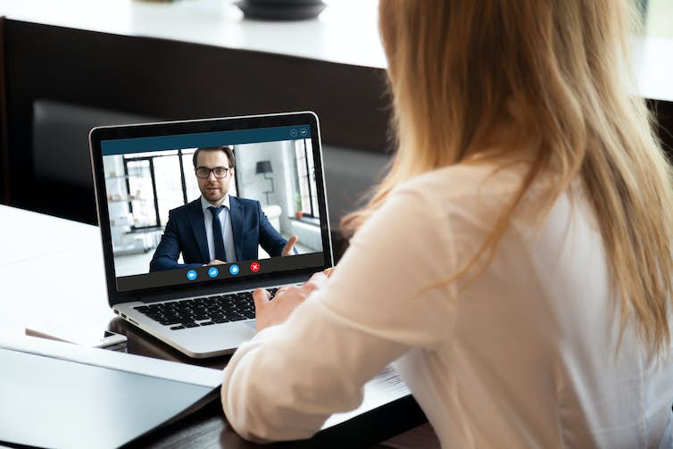 A man being virtually interviewed on a computer