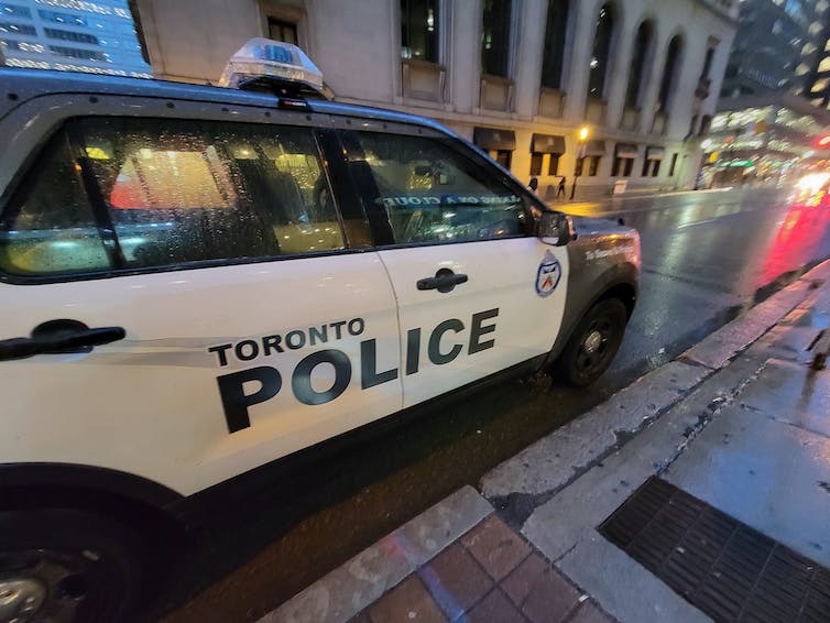 A Toronto police cruiser parked on a city street.