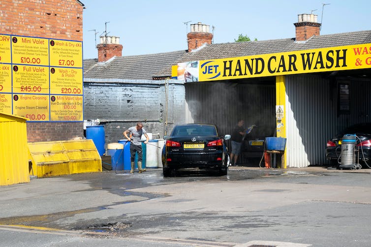 Hand car wash in progress.