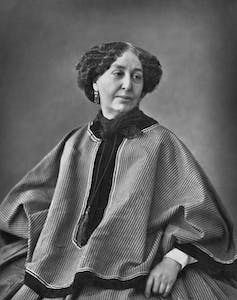 A black and white photo of a woman sitting down